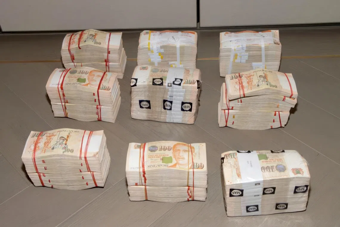 Some of the cash seized in the crackdown on 15 August 2023. The operation, conducted across several Good Class Bungalows and high-end condominiums simultaneously, nabbed 10 individuals. 