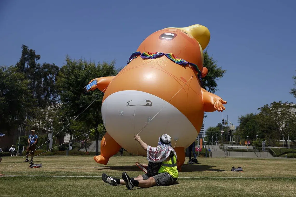 Protesters flying a Baby Trump ballon during the Rage Against The Regime rally in Los Angeles, California, US, on Aug 2, 2025. The rally is a part of the nationwide protests against the Trump administration. 