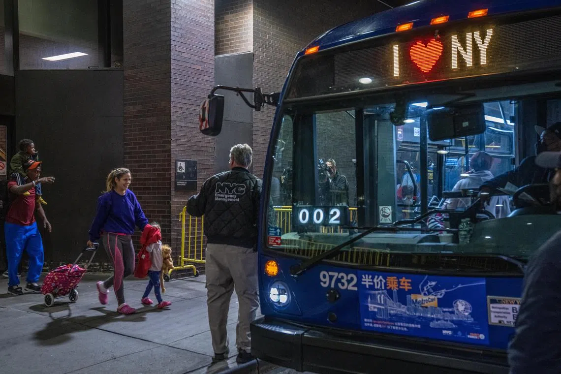 Migrants from Texas who arrived at New York City’s Port Authority bus terminal board another bus headed for a family intake center, in Manhattan, May 3, 2023. 