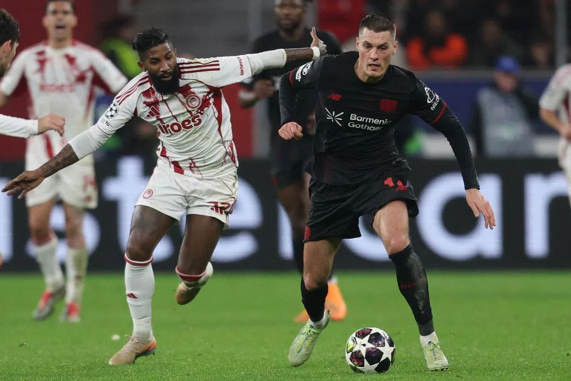 Soccer Football - UEFA Champions League - Play Off - Second Leg - Bayer Leverkusen v Olympiacos - BayArena, Leverkusen, Germany - February 24, 2026 Bayer Leverkusen's Patrik Schick in action with Olympiacos' Rodinei REUTERS/Leon Kuegeler