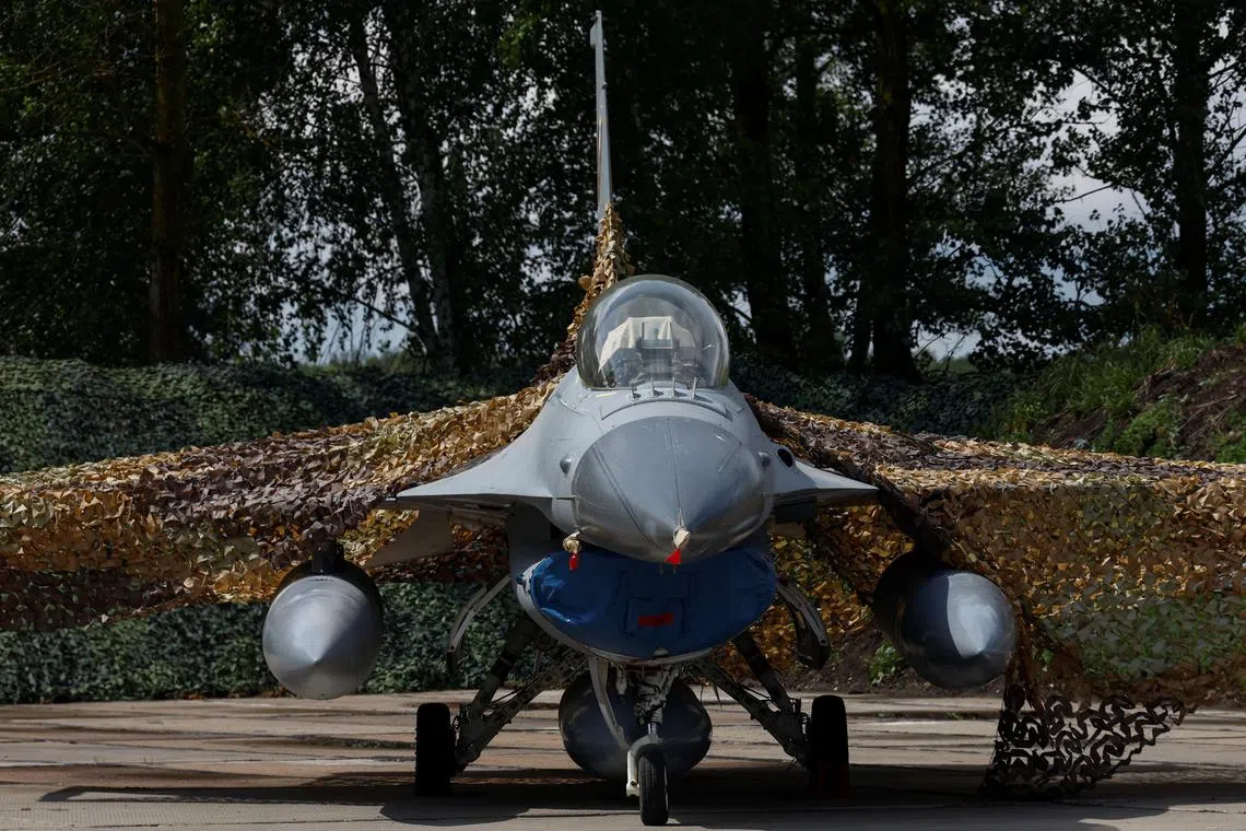 A Ukrainian Air Forces F-16 fighting aircraft is seen on the ground, amid Russia's attack on Ukraine, in an undisclosed location, Ukraine August 4, 2024. REUTERS/Valentyn Ogirenko/File Photo
