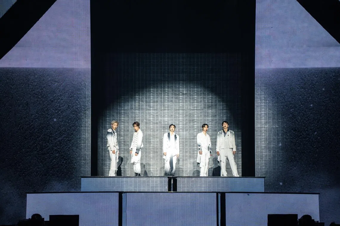 Exo performing the song Crown (2026) during their concert at the Singapore Indoor Stadium on July 24. The five active members are (from left) Chanyeol, Kai, Suho, D.O. and Sehun.