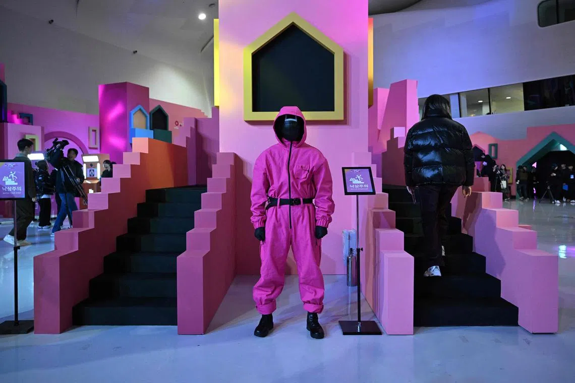 Visitors look around an activation zone for the Netflix series Squid Game Season 2 at Dongdaemun Design Plaza in Seoul. 