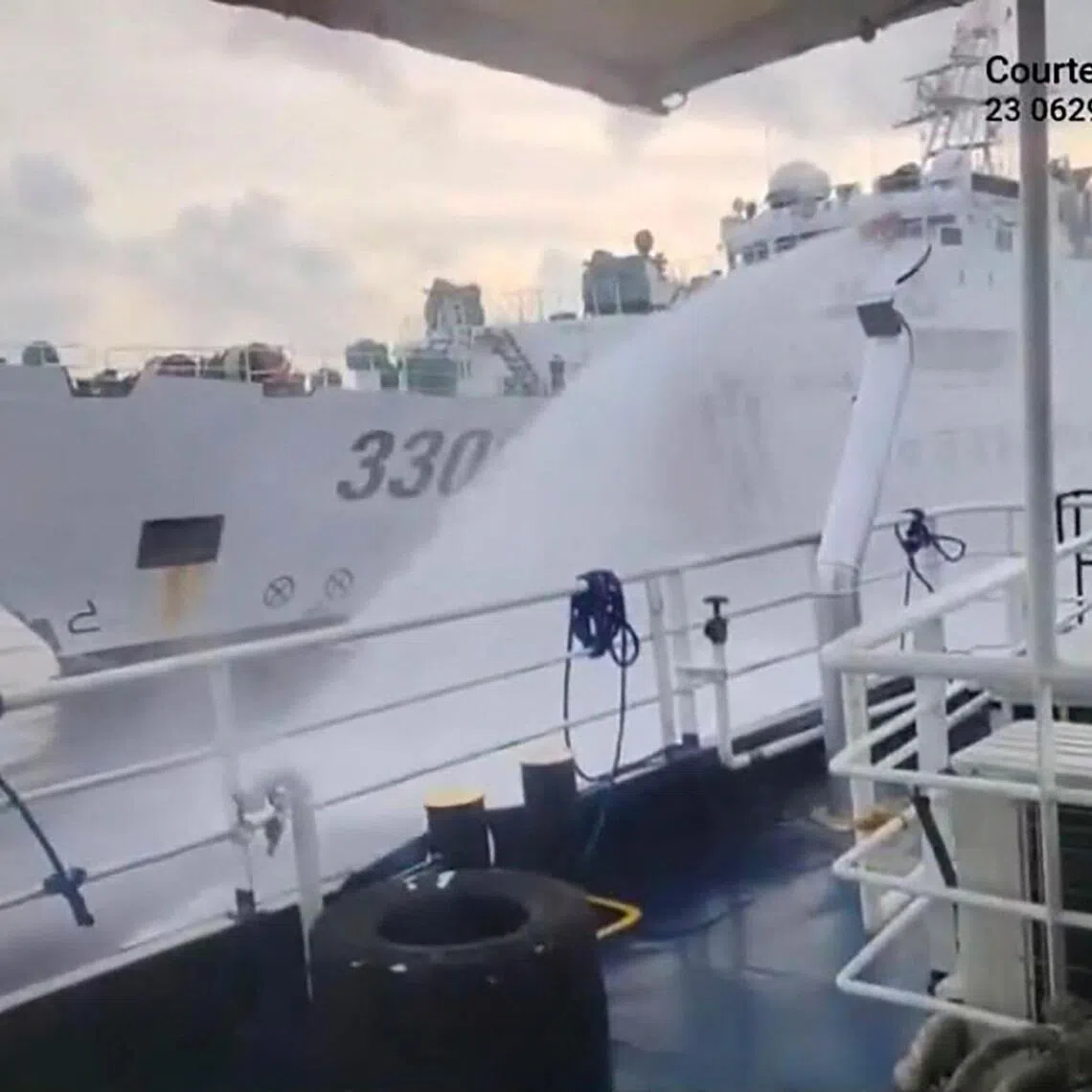 This handout photo shows a Chinese coast guard ship firing a water cannon at a Philippine research vessel near the disputed Scarborough Shoal on July 23.