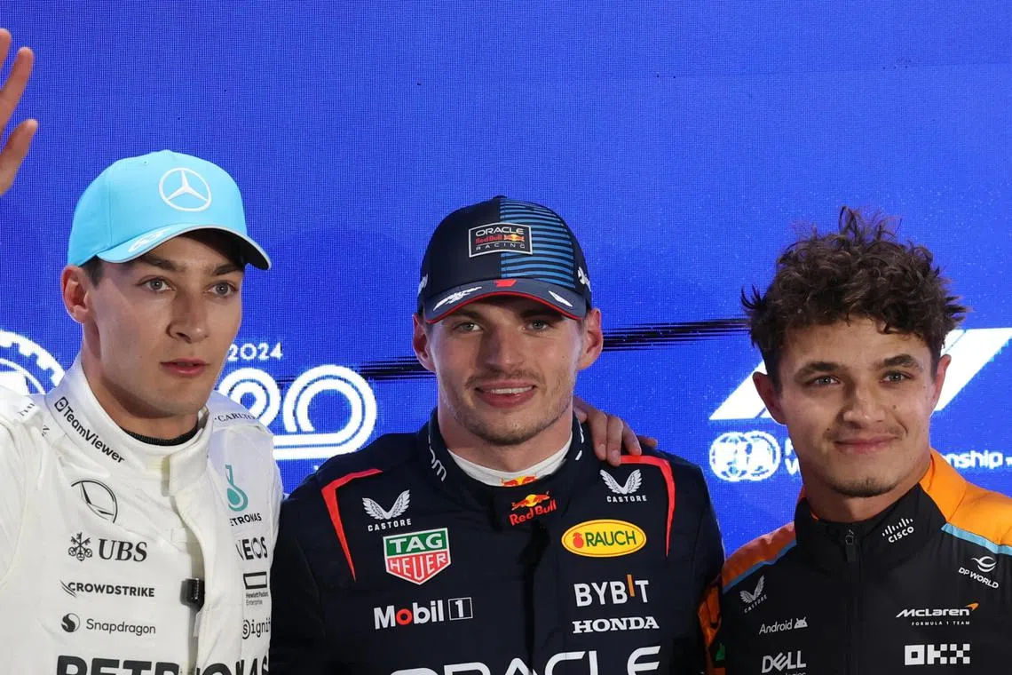 Max Verstappen (centre) and George Russell (left) posing for a photo with Lando Norris after the Qatar Grand Prix.