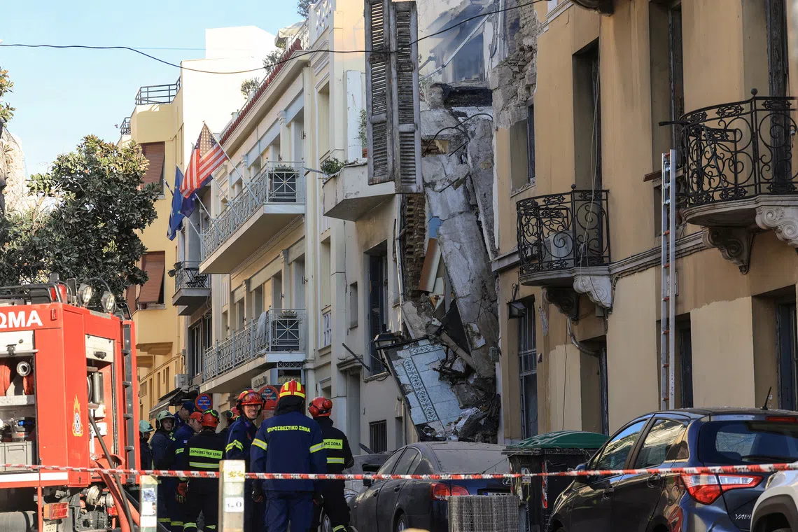 Emergency personnel work at the site where an old building partially collapsed following an explosion, at the touristy Plaka area in central Athens, Greece, in Sept 25.
