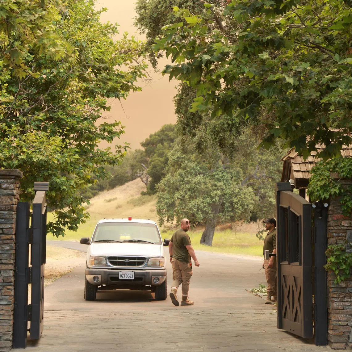 Firefighters man the entrance to the late pop star Michael Jackson’s Neverland Ranch in Los Olivos, California.