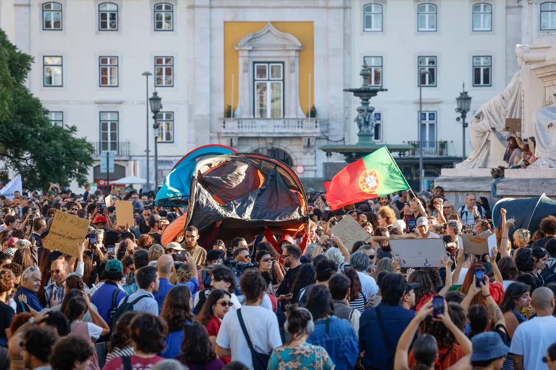 Demonstrators gather at Rossio Square during a housing protest in Lisbon, Portugal, on Oct 17.