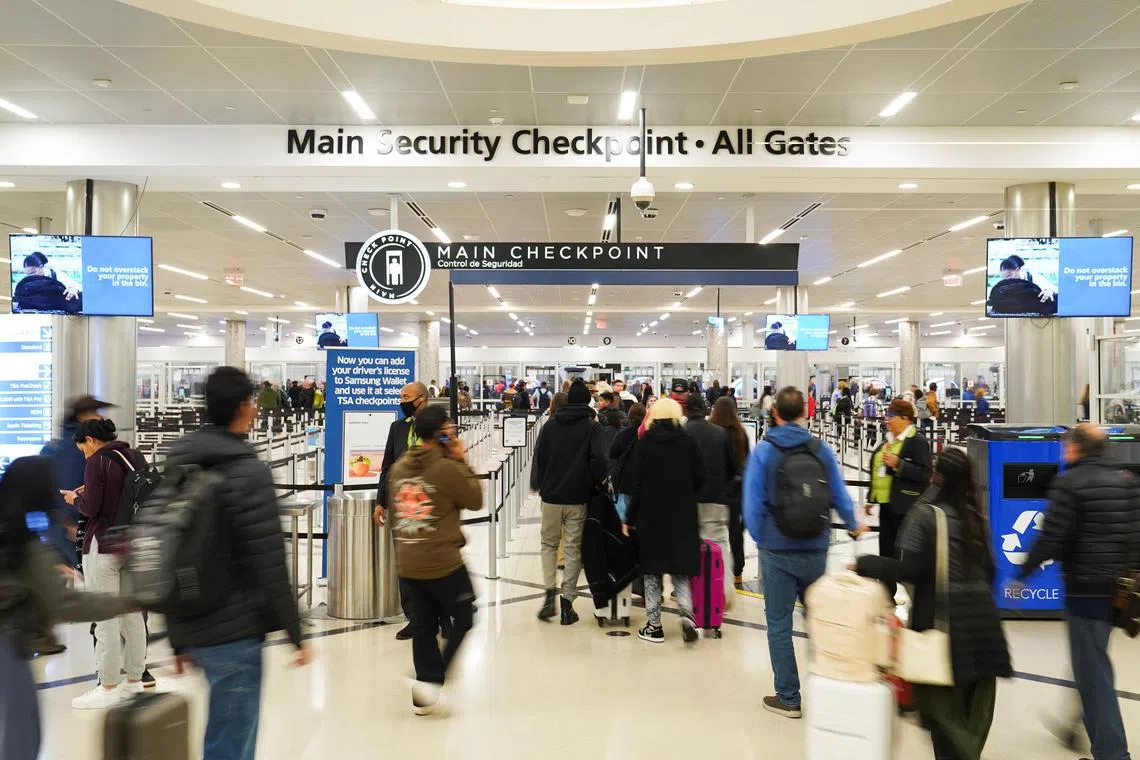 FILE PHOTO: People walk through the Hartsfield-Jackson Atlanta International Airport, in Atlanta, Georgia, U.S., November 27, 2024. REUTERS/Megan Varner/File Photo