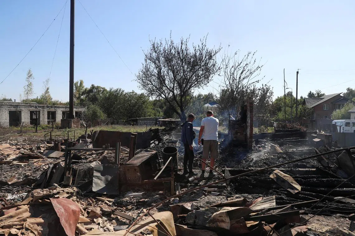 Residents stand at a site of a building destroyed by a Russian military strike, amid Russia's attack on Ukraine, in the village of Yampil, in Sumy region, Ukraine September 6, 2024. REUTERS/Maksym Kishka