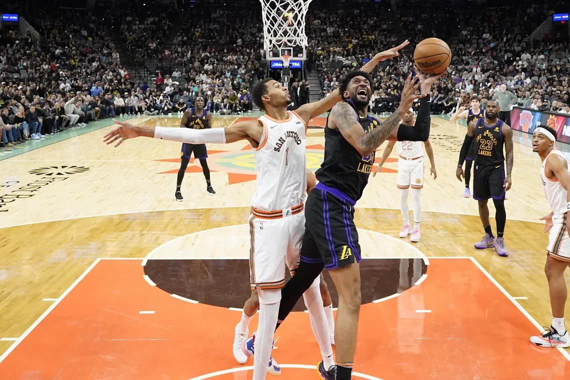 Los Angeles Lakers forward Christian Wood shoots over San Antonio Spurs forward Victor Wembanyama during the first half at Frost Bank Centre.