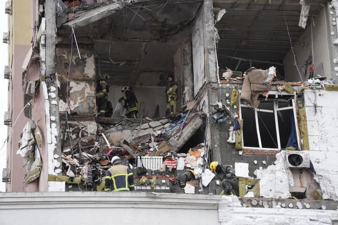 Ukrainian rescuers look through rubble inside a damaged residential building following Russian drones and missiles attack, in Kyiv, on Dec 27, 2025.