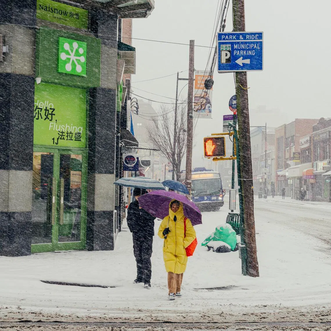 Pedestrians brave a winter storm in Queens, in New York, on Jan 25.