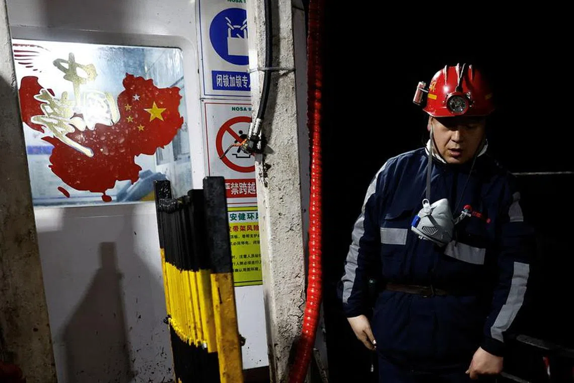 An employee walks near a sticker in the shape of China's map, at Hongliulin Coal Mine during a Huawei-organised media tour, in Shenmu of Yulin city, Shaanxi province, China April 25, 2023. REUTERS/Tingshu Wang/File Photo