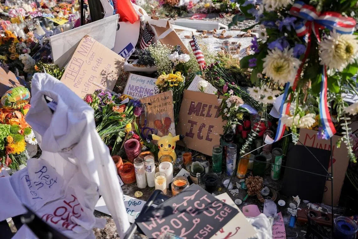 Flowers, candles, and signs left by mourners at a memorial for Alex Pretti near the scene of a fatal shooting by a federal law enforcement officer in Minneapolis.