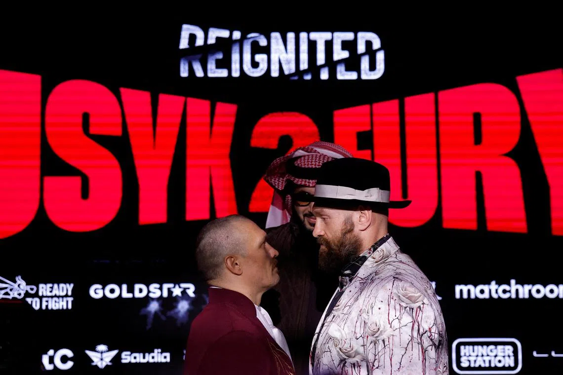 Oleksandr Usyk and Tyson Fury during the press conference ahead of their fight.