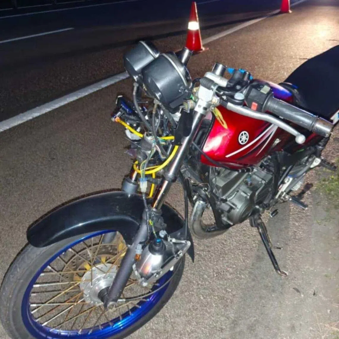The motorcycle ridden by the 20-year-old Singaporean after it was struck by a lorry on the North-South Expressway.