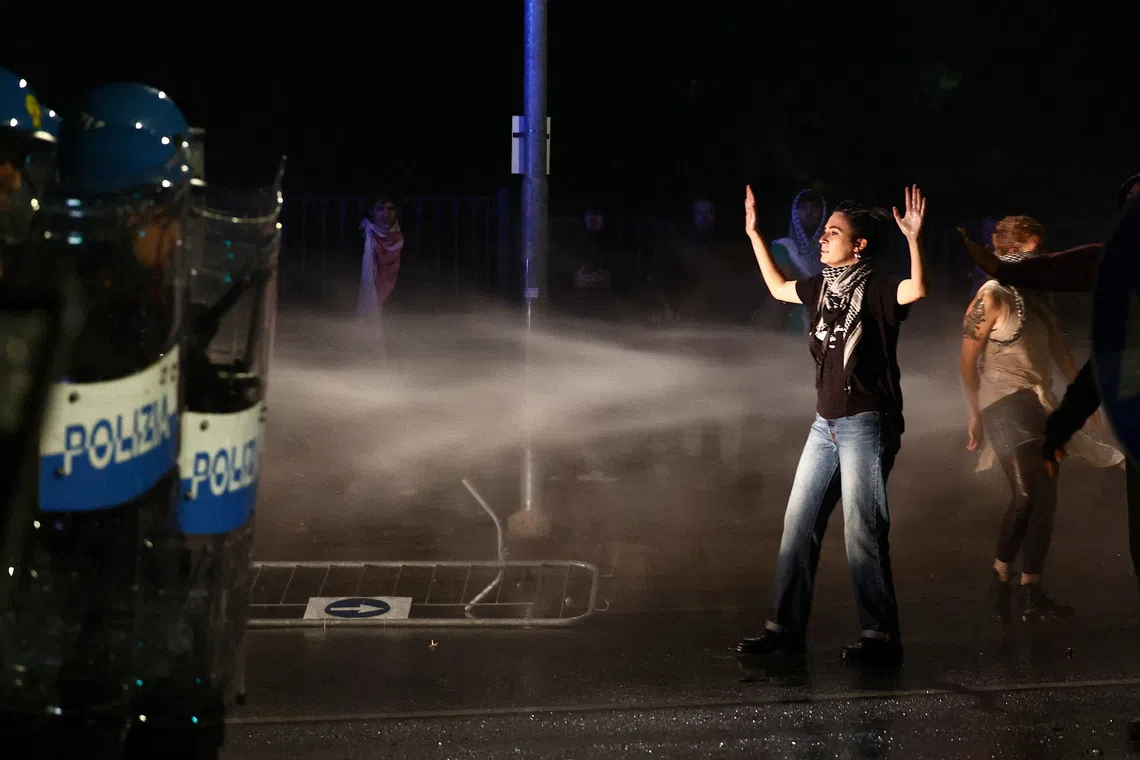Riot police officers using a water cannon on Protesters as they march against the Israeli football team, during a pro-Palestinian demonstration ahead of the FIFA World Cup soccer match between Italy and Israel, in Udine, Italy , on Oct 14, 2025.