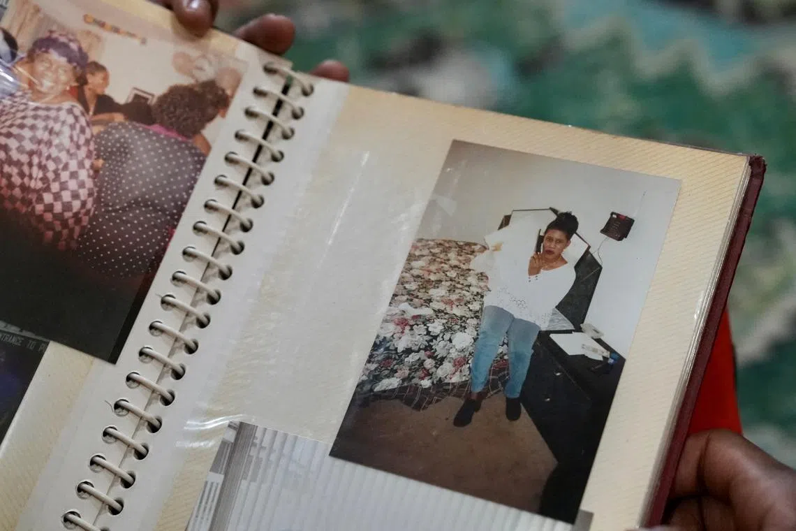 Mohamed Alghali, 33, looks at an album containing photographs of his mother, Rabbiatu Kuyateh, at the home they shared in Bowie, Maryland, U.S., December 10, 2025. Kuyateh was deported in November to Ghana, which has an agreement with the Trump administration to take West African migrants who cannot easily be sent to their home countries. She said she was then flown against her will to her native Sierra Leone, where she feared she could be tortured because of her father's ties to the political opposition. REUTERS/Julio-Cesar Chavez
