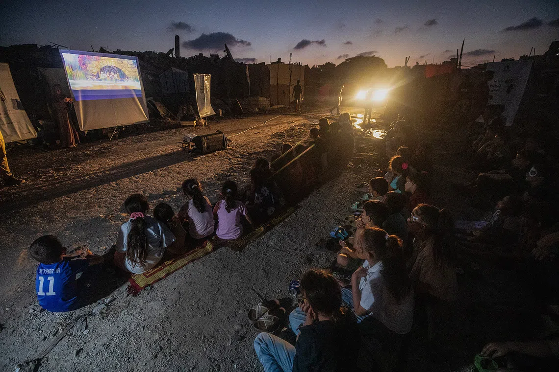 epa13229354 Internally displaced Palestinian children watch a movie at a makeshift open-air cinema near the ruins of destroyed buildings in the Al-Sheikh Redwan neighborhood in Gaza City, Gaza Strip, 10 September 2026. Around 1.9 million people in Gaza, nearly 90 percent of the population, have been displaced since the Israel-Hamas conflict began in October 2023, according to the UN. EPA/MOHAMMED SABER
