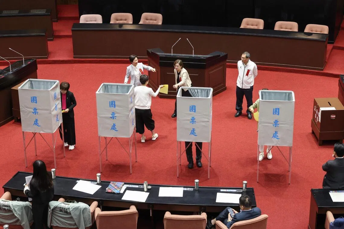 Members of Taiwan's opposition parties vote on an impeachment motion against President Lai Ching-te on May 19.