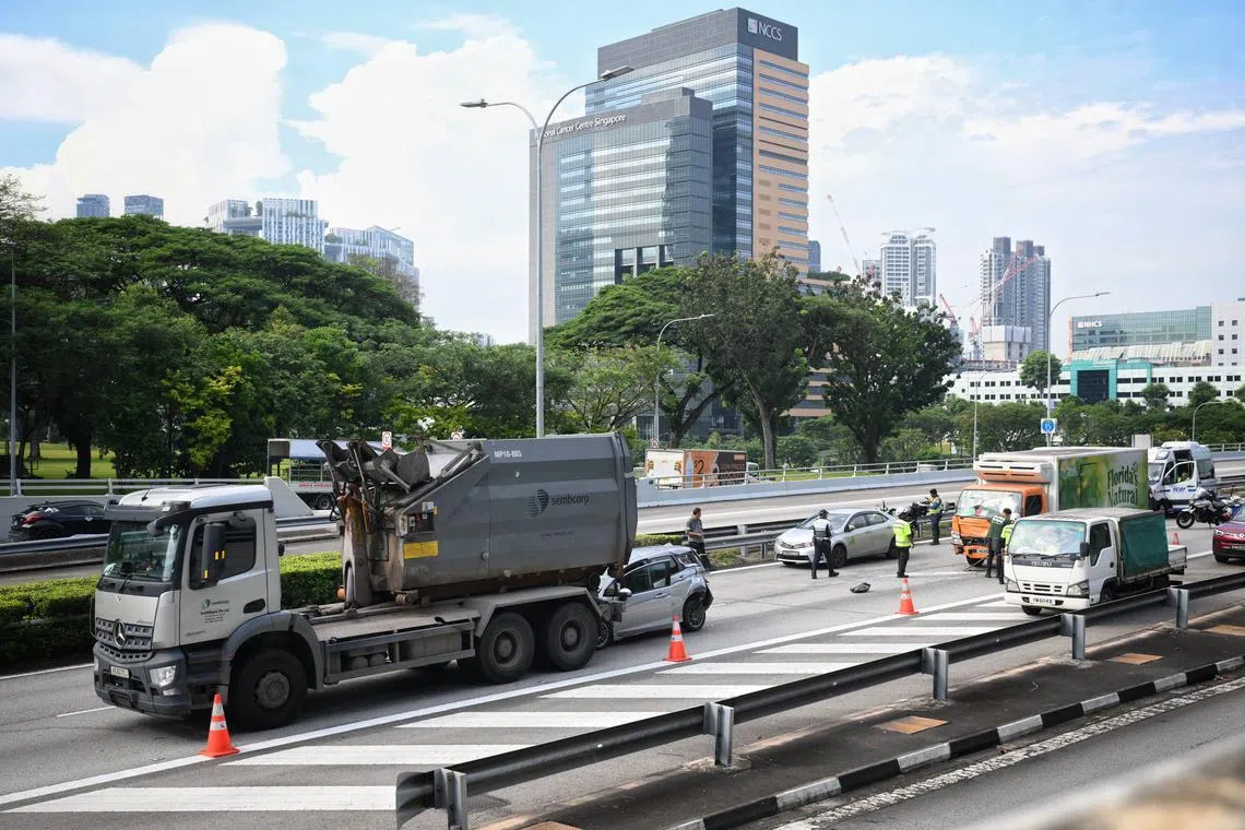 The front passenger door of the car was open, and both the front and rear bumpers appeared badly damaged.