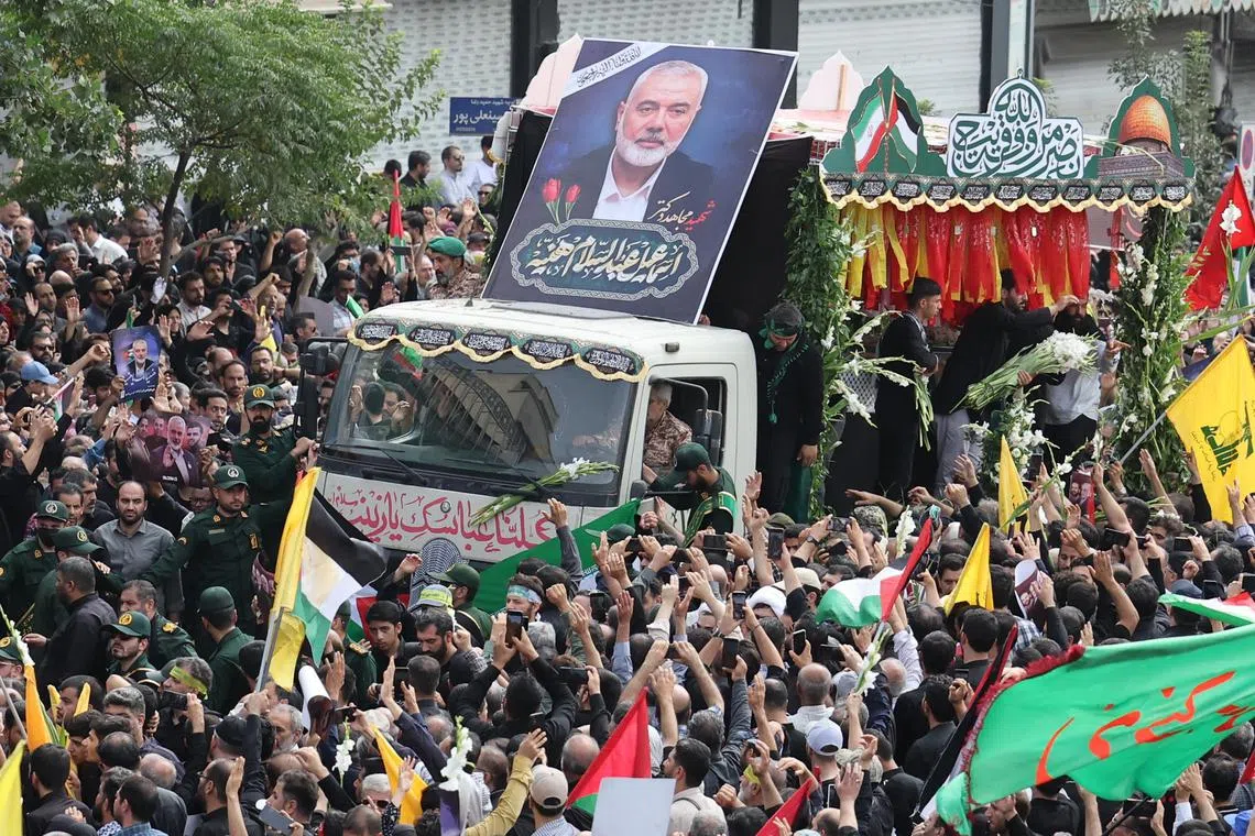 epaselect epa11514508 People gather around a truck carrying the coffins of Hamas late political leader Ismail Haniyeh and his bodyguard, during a funeral procession in Tehran, Iran, 01 August 2024. Haniyeh and one of his bodyguards were targeted and killed in Tehran on 31 July 2024, the Iranian Revolutionary Guard Corps (IRGC) confirmed.  EPA-EFE/ABEDIN TAHERKENAREH