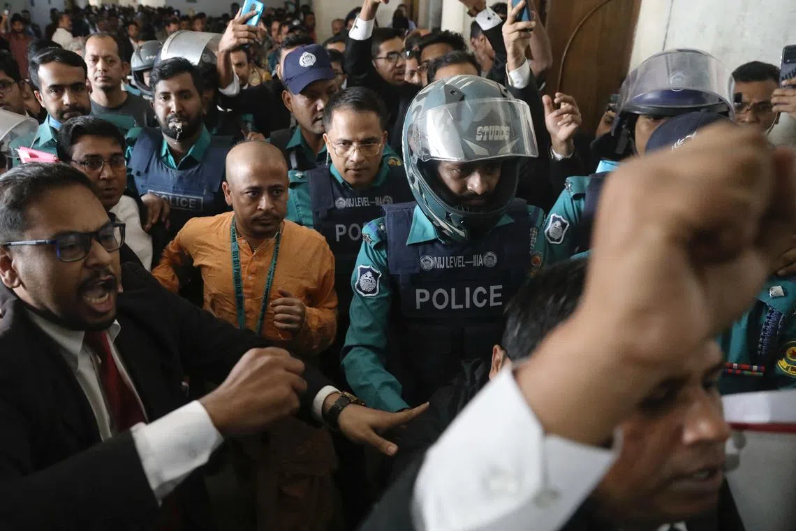 Chinmoy Krishna Das, a Hindu leader associated with the International Society for Krishna Consciousness (ISKCON), who faces several charges, is escorted by the police at the Chattogram Metropolitan Magistrate Court, in Chattogram, Bangladesh, November 26, 2024. REUTERS/Stringer