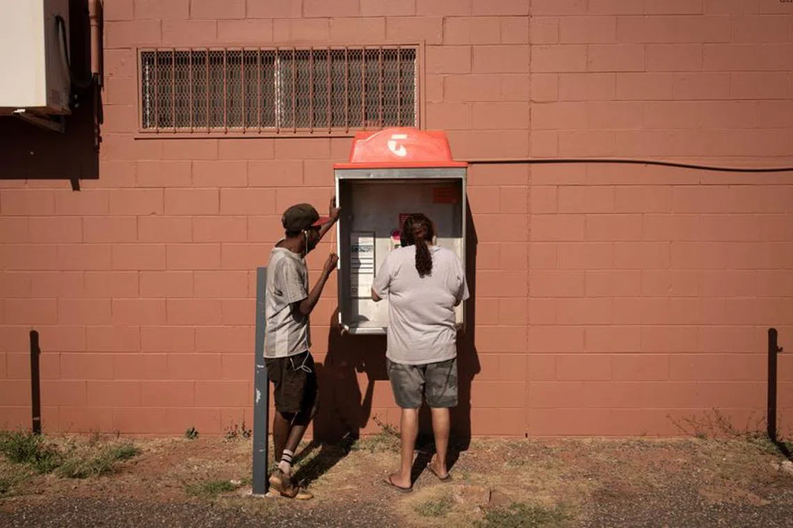 Local residents Rosemary and Jonathan use the landline phone booth, as the local phone tower is out of service that day, ahead of a nationwide referendum on Indigenous issues, in Hermannsburg, Australia, September 18, 2023. On October 14, Australians will vote on whether to recognise Aboriginal and Torres Strait Islander people in the constitution and enshrine in it an advisory body called the Voice to Parliament that would give non-binding advice to lawmakers on matters concerning the continent's first inhabitants. Surveys show nationwide support for the Voice declining from around 60 per cent earlier this year to around 40 per cent, with voters prioritising economic issues instead. Experts have partly attributed the slump to misinformation, along with a lacklustre "Yes" campaign and conservative opposition. REUTERS/Jaimi Joy