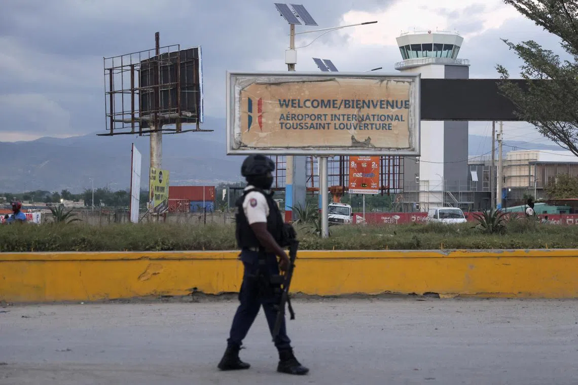 FILE PHOTO: A police officer stands at one of the entrances of Toussaint Louverture International Airport in Port-au-Prince, Haiti, December 11, 2024. REUTERS/Ralph Tedy Erol/ File Photo