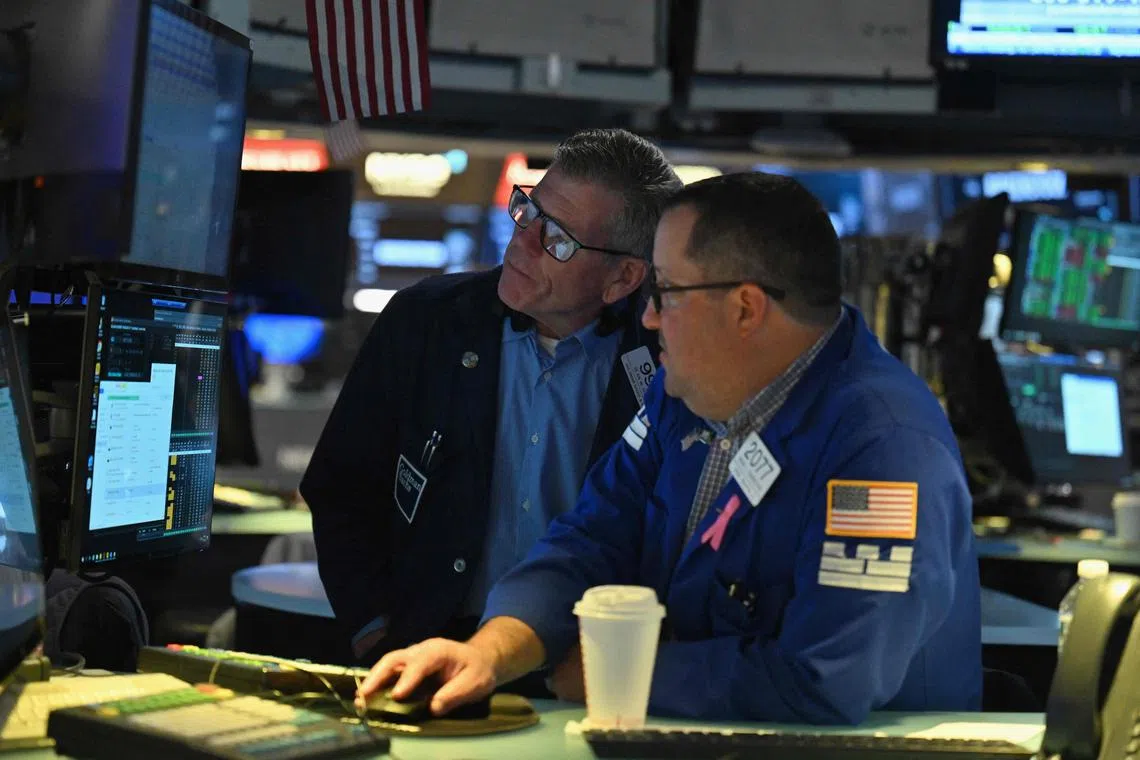 Traders work on the floor of the New York Stock Exchange, in New York City.