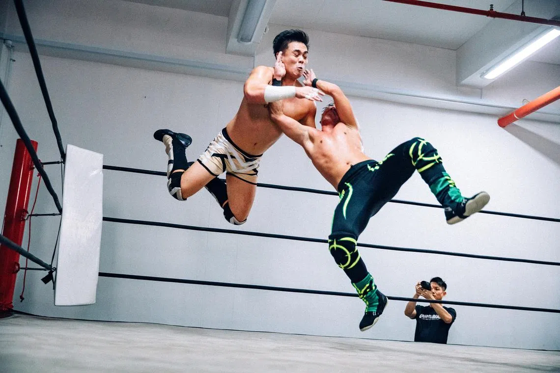 Wilson Loh (in dark tights), also known as Hotshot, wrestles his opponent Big Dave for the Grapplemax openweight championship belt on Nov 11, 2023.
