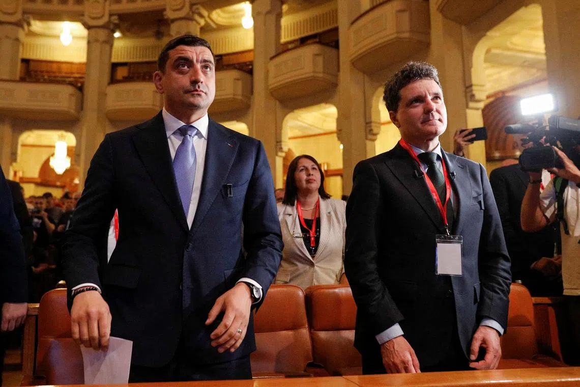 George Simion (left) and Nicusor Dan (right) attend a meeting of the National Union Bloc in Bucharest, Romania, May 7 2025. Inquam Photos/Malina Norocea via REUTERS