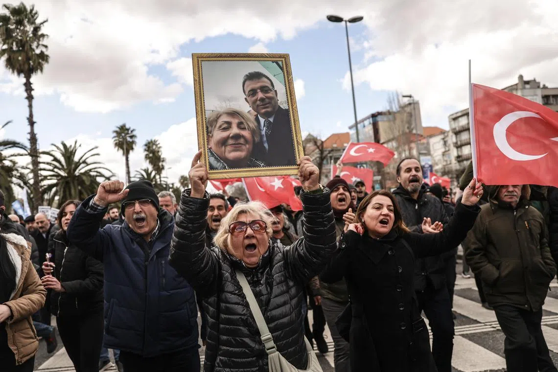 A supporter holding up a picture of detained Istanbul Mayor Ekrem Imamoglu as they gathered in Istanbul on March 19.