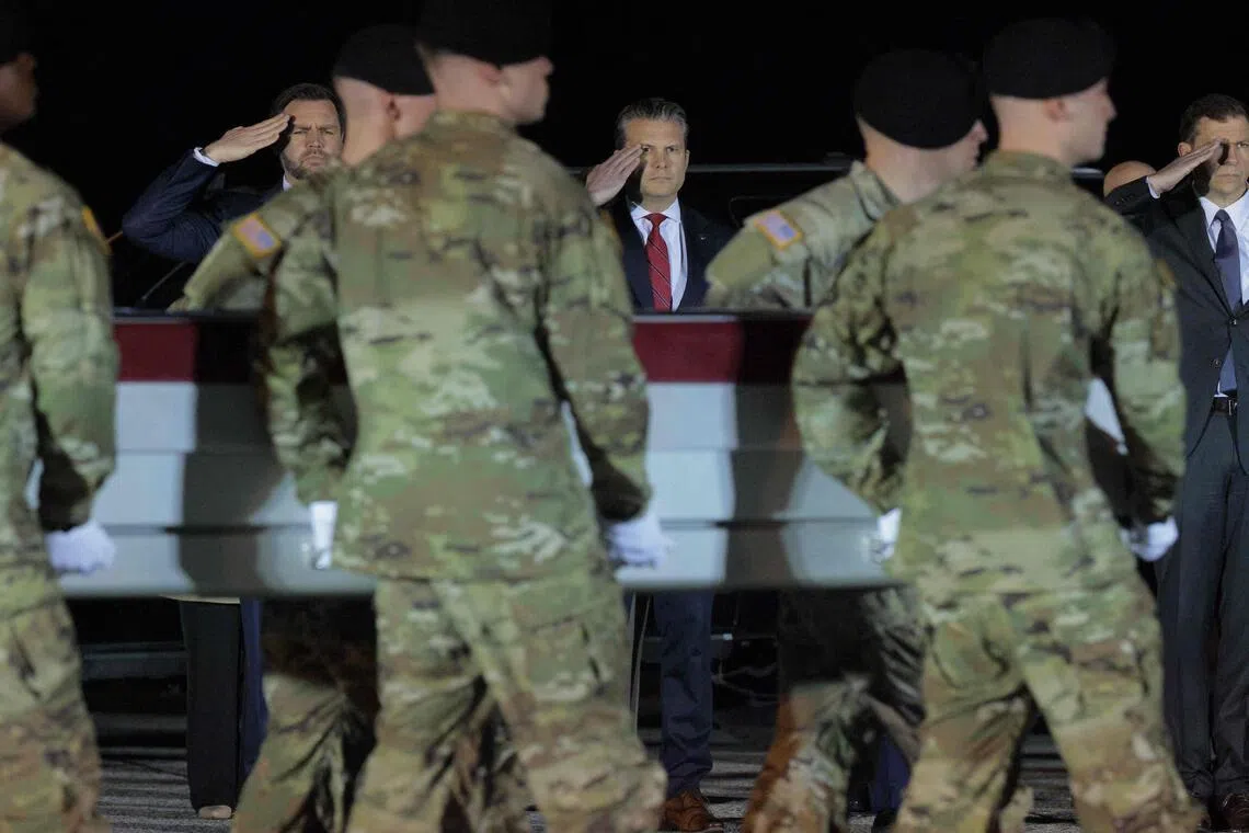 US Vice-President J.D. Vance (left) and Defence secretary Pete Hegseth salute as a US Army moves a flag-draped transfer case containing the remains of Army Sgt. Benjamin Pennington at Dover Air Force Base on March 9, 2026.