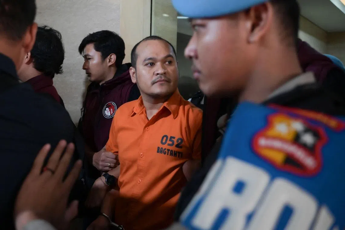 Chaowalit Thongduang (C), one of Thailand's "most wanted" fugitives who was on the run after escaping Thai custody and fleeing to Indonesia last year, is escorted at the National Police Criminal Investigation Agency office in Jakarta on June 4, 2024, following his arrest on the Indonesian resort island of Bali on May 30. Chaowalit, also known by the moniker "Pang Na Node", was wanted in Thailand on multiple charges including murder and drug-related offenses. (Photo by Bay ISMOYO / AFP)