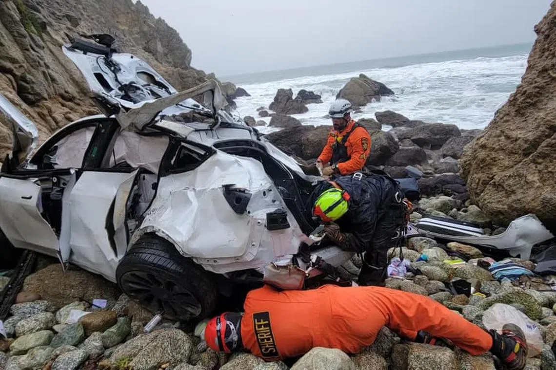 Rescuers at the scene of the crash, off Highway 1 in Northern California on Monday. 