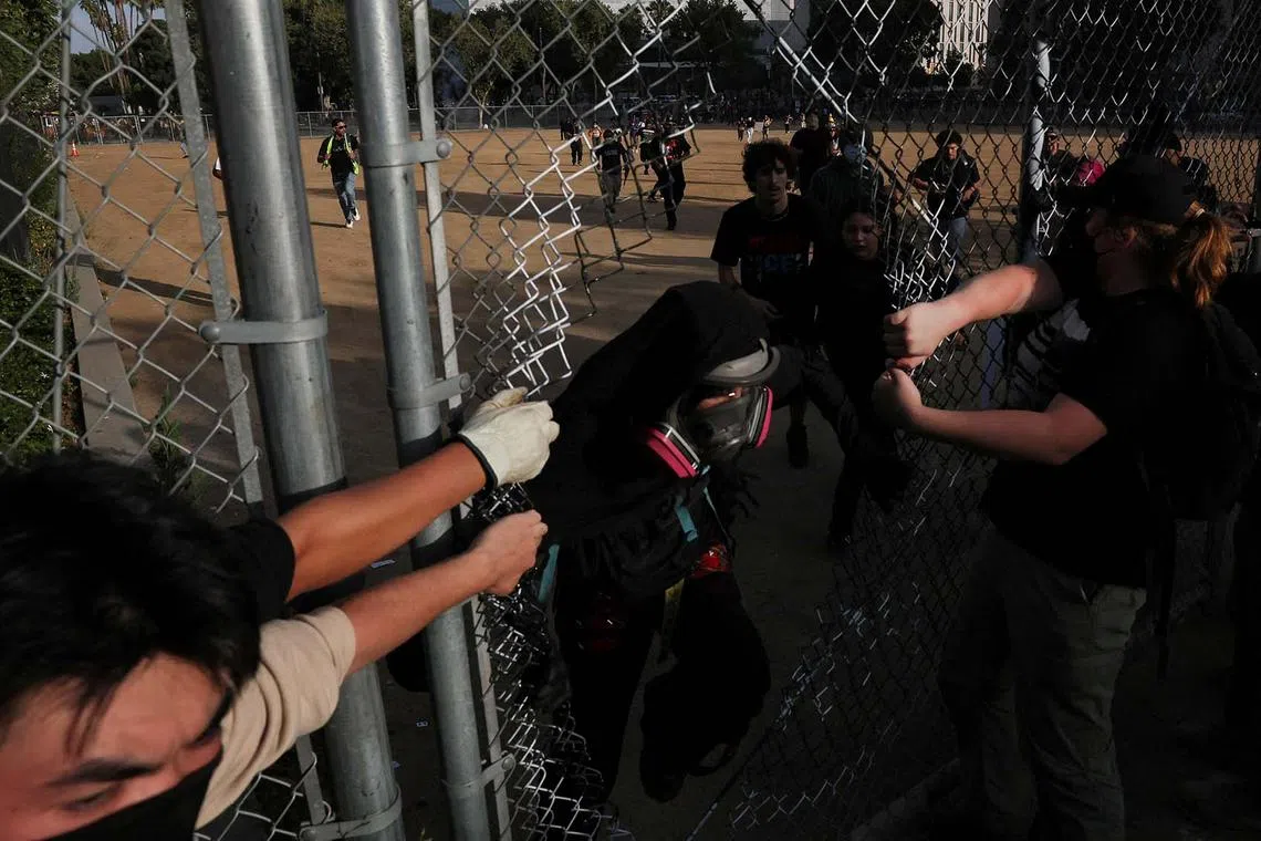 Demonstrators pass through a fence as they run from the police during a No Kings Day protest against President Donald Trump's policies, in Los Angeles, California, U.S., June 14, 2025. REUTERS/Leah Millis TPX IMAGES OF THE DAY
