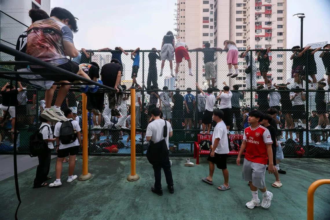 Members of the public crowding at Chinatown Complex basketball court to catch a glimpse of basketball influencer Matt Kiatipis on Oct 6, 2026. ST PHOTO: BRIAN TEO