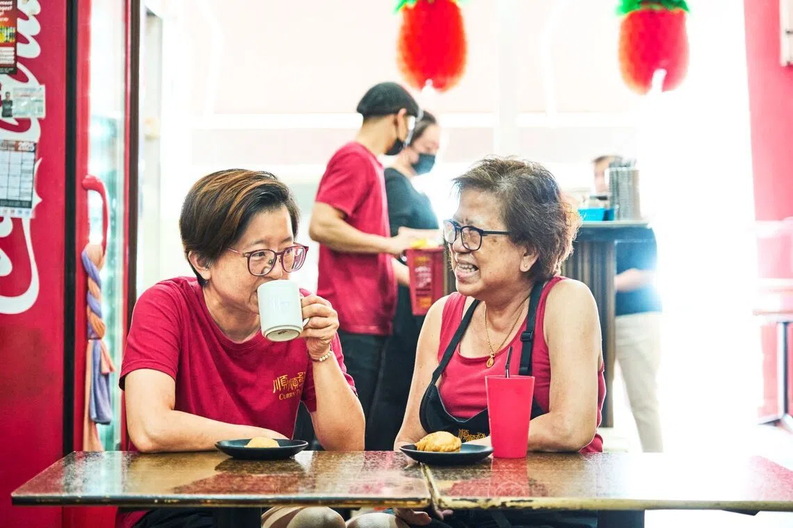 Ms Tay Mui Lan (left), who was diagnosed with a brain tumour five years ago, with her mother (right). Together, they run the family curry puff business along East Coast Road.