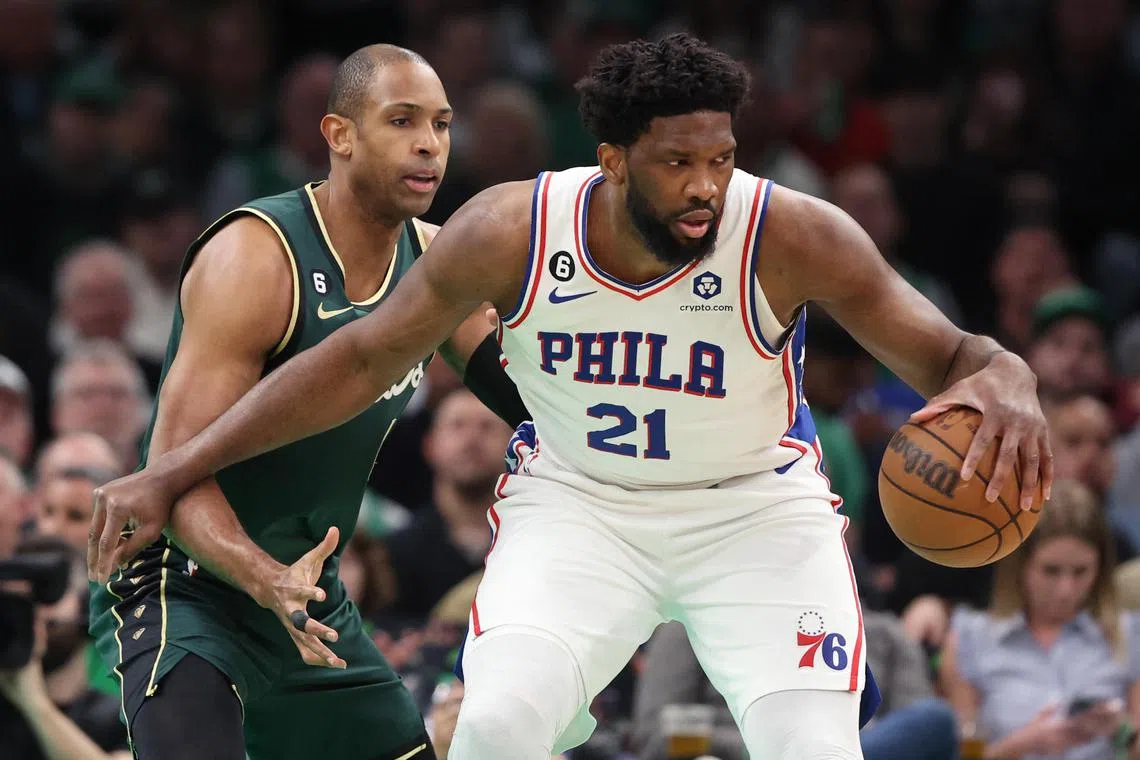 Joel Embiid (No. 21) scored 33 points, grabbed seven rebounds and blocked four shots to lead the Philadelphia 76ers to a 115-103 road victory over the Boston Celtics on Tuesday. 
