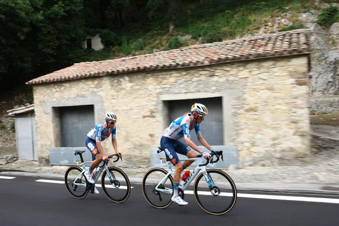 Team dsm-firmenich PostNL's Romain Bardet and Frank van den Broek during Stage 1 of the 2-24 Tour de France.
