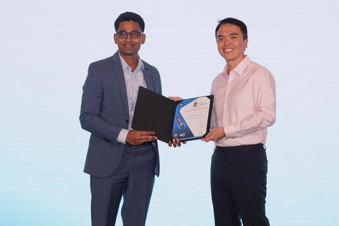 Dinesh Kumar Balraj (left), senior director and head of fleet operations east, fleet management and technology at Maersk, receiving an award from MPA chief executive Ang Wee Keong during the launch of Singapore Safety@Sea Week at Conrad Singapore Orchard on Aug 17.