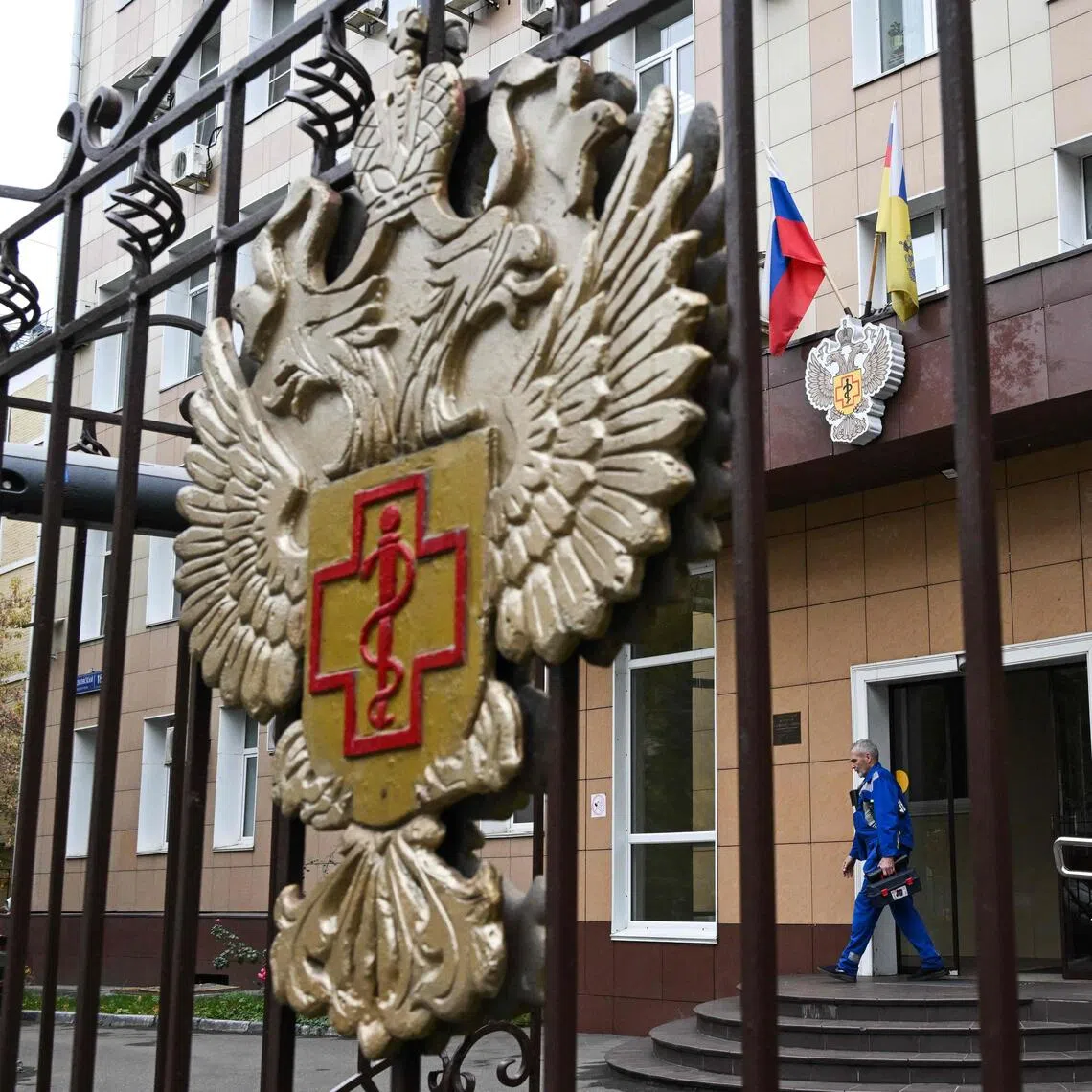 A maintenance worker walks out of the headquarters of Russia’s consumer and health watchdog Rospotrebnadzor in Moscow.