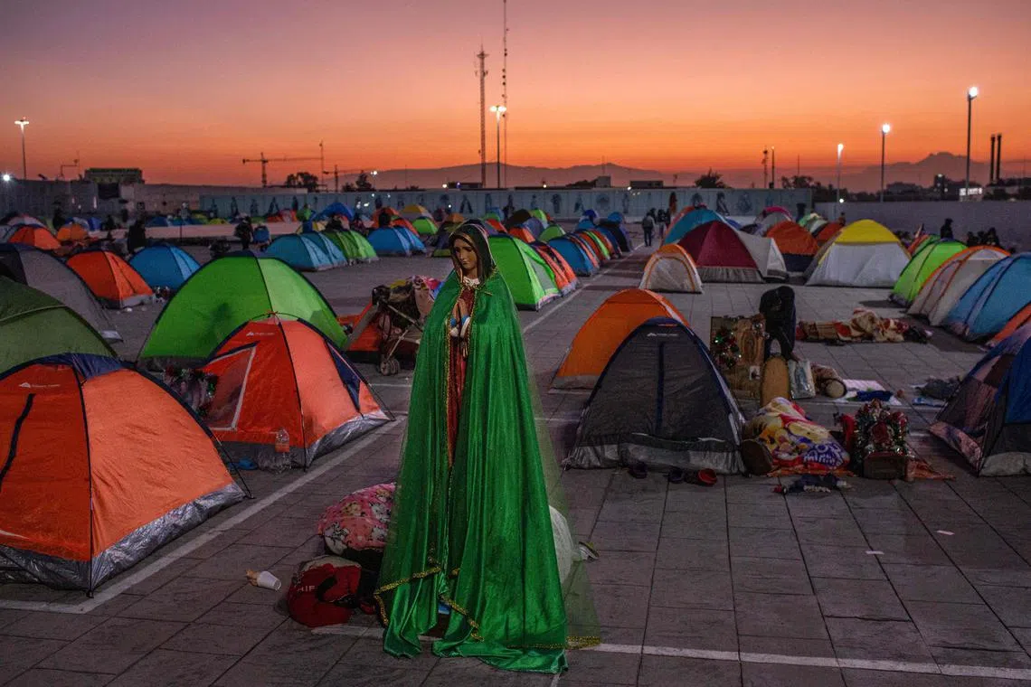 Pilgrims sleep inside their tents next to images of the Virgin of Guadalupe outside the Basilica of Guadalupe in Mexico City on Dec 11, 2022.