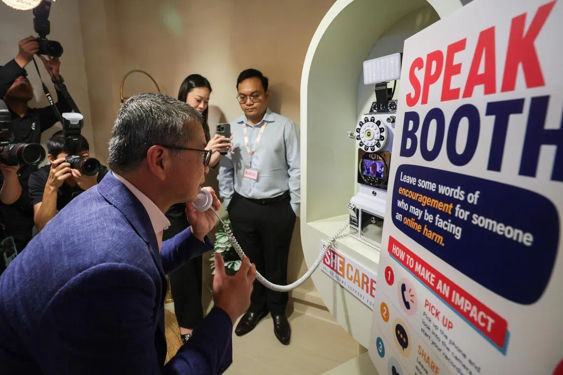 Edwin Tong (left), Minister for Law and Second Minister for Home Affairs, records a supportive video message at the Speak Up Booth, during a tour of the SHECARES Centre on July 24.