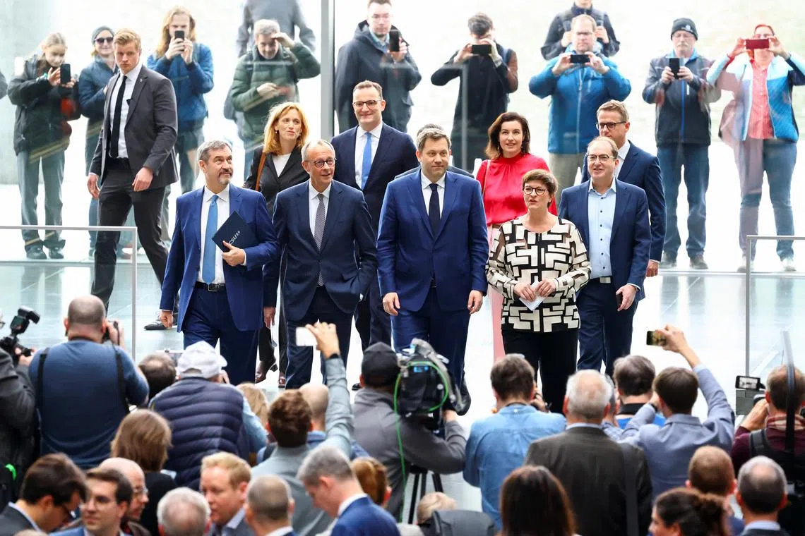 FILE PHOTO: Germany's chancellor-in-waiting and leader of the Christian Democratic Union party (CDU) Friedrich Merz, Christian Social Union (CSU) leader and Bavarian Premier Markus Soeder, co-leaders of the Social Democratic party (SPD) Saskia Esken and Lars Klingbeil attend a press conference after reaching an agreement on their coalition government in Berlin, Germany, April 9, 2025. REUTERS/Fabrizio Bensch/File Photo