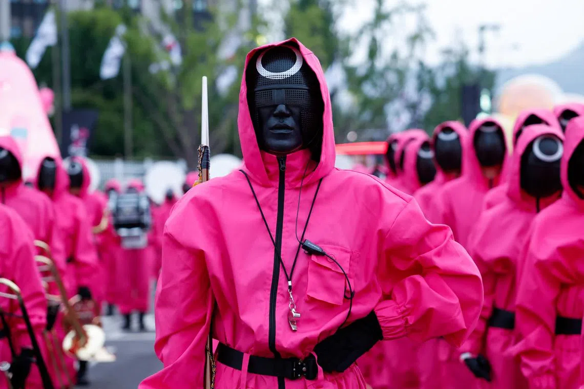 Performers dressed as Squid Game soldiers preparing to parade through central Seoul, on June 28.
