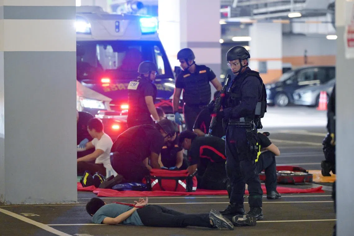 zybeat18/ ST20241118_202495200707/Ng Sor Luan/Exercise Heartbeat 2024, a police counter terrorism exercise at ITE College West on Nov 18, 2024. The SCDF sets up an area to perform triage on the injured while a police officer stands guard over a neutralized terrorist. 