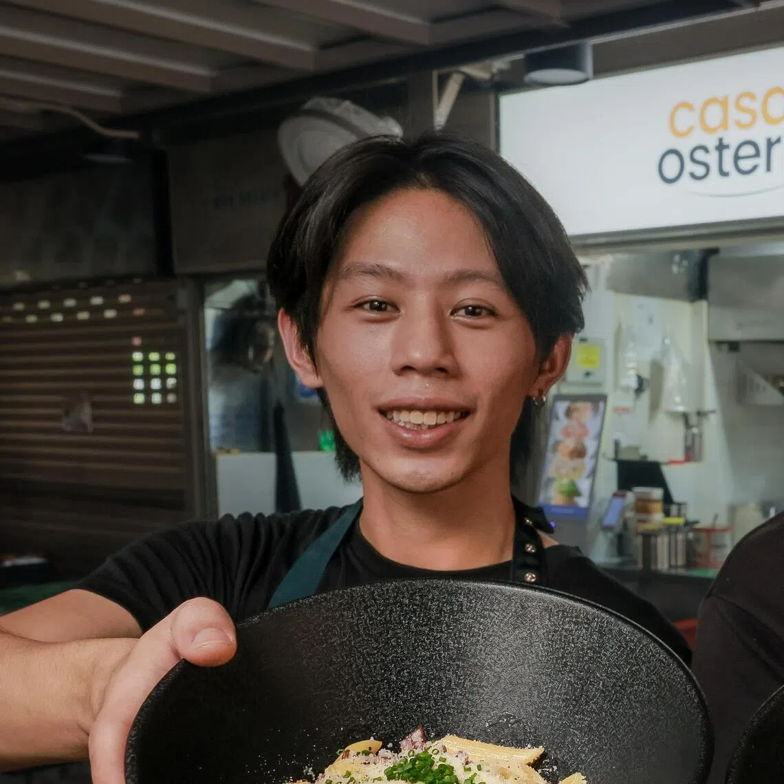 Jerome Chin (left) and Michael Lam with plates of Penne Carbonara and Linguine Pesto at their hawker stall, Casa Osteria, at Chomp Chomp Food Centre.